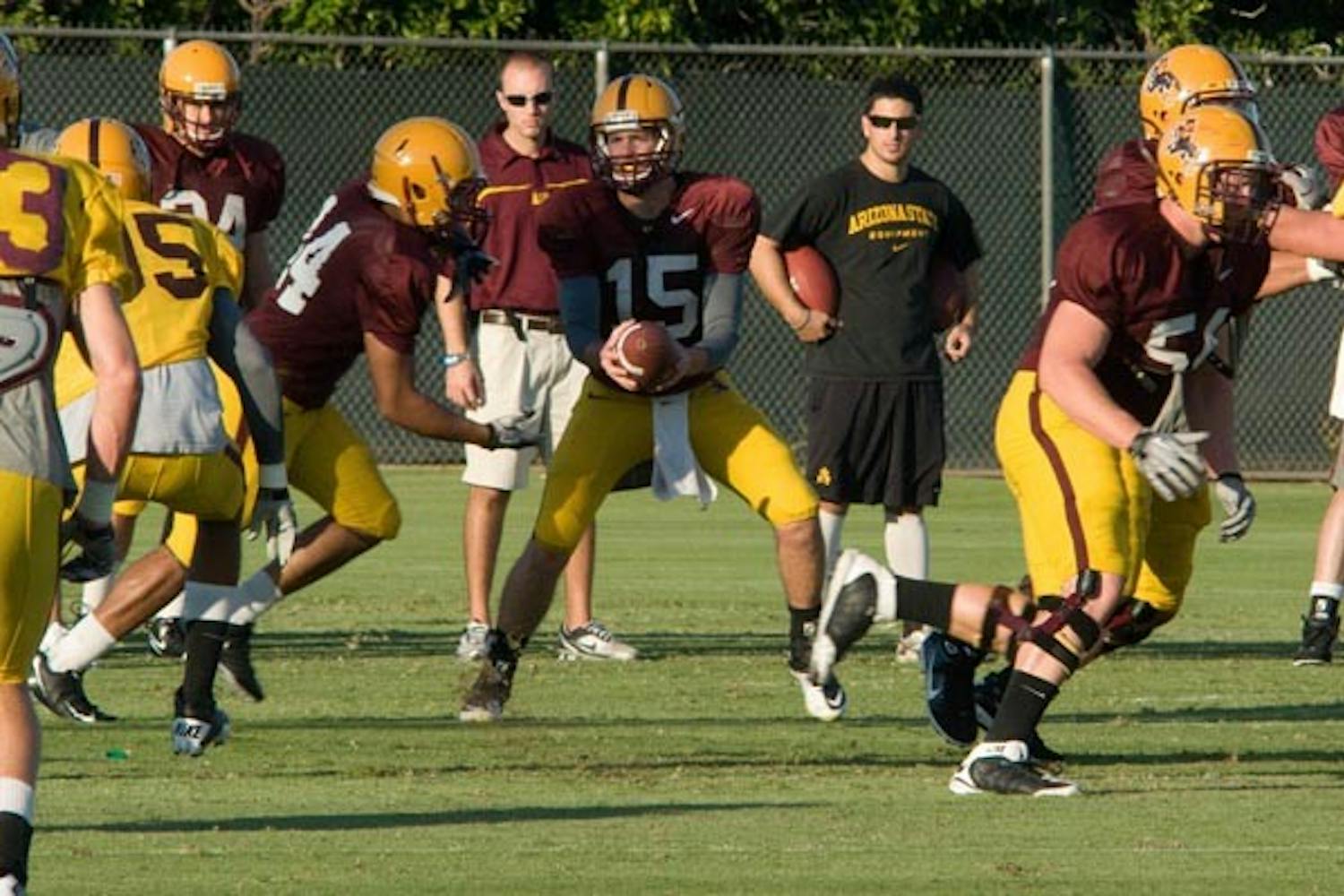 SCOUTING REPORT: Freshman quarterback Taylor Kelly leads the offense during a scout team scrimmage at football practice Thursday. Kelly was 7-of-10 passing with a touchdown in the midseason scrimmage. (Photo by Aaron Lavinksy)