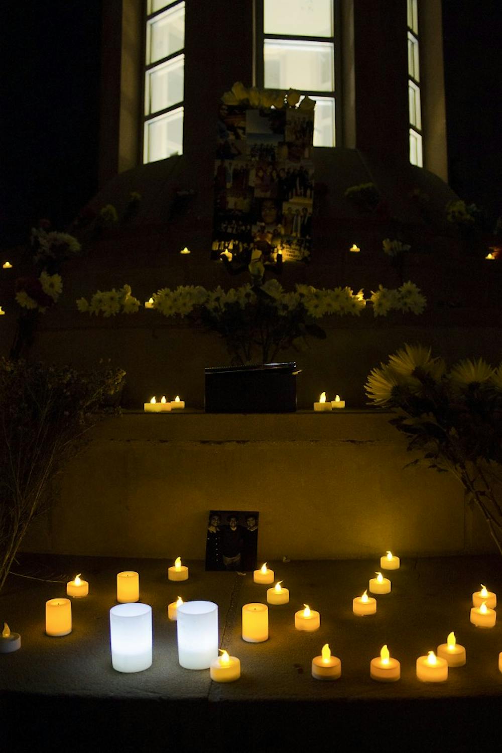 Friends and family lit candles during the vigil on Feb. 19, 2015, at Hayden Lawn in memory of an ASU student. (Shiva Balasubramanian/ The State Press)