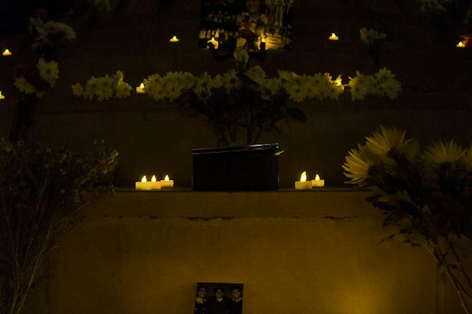 Friends and family lit candles during the vigil on Feb. 19, 2015, at Hayden Lawn in memory of an ASU student. (Shiva Balasubramanian/ The State Press)