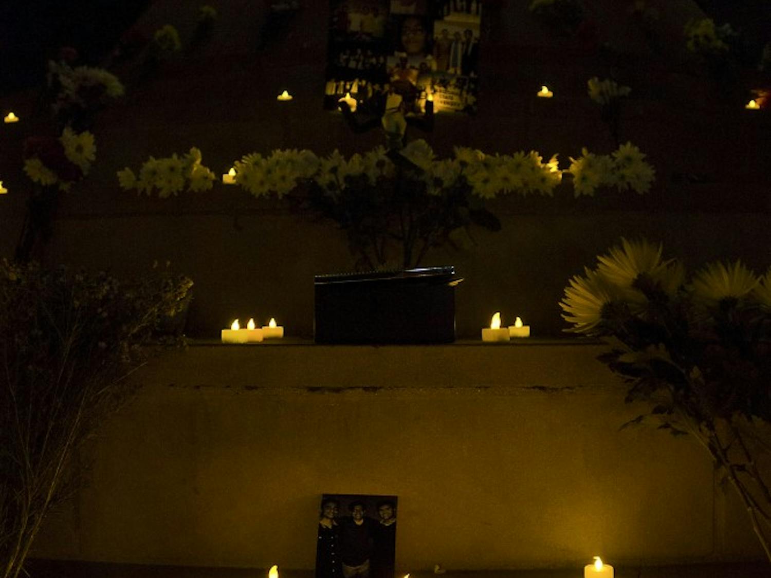 Friends and family lit candles during the vigil on Feb. 19, 2015, at Hayden Lawn in memory of an ASU student. (Shiva Balasubramanian/ The State Press)