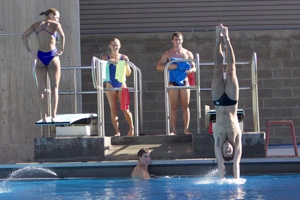 Breaking the Surface: Junior Cameron Bradshaw enters the water while his teammates check out his form. The ASU dive team boasts three returning Olympians and adds a freshman who won gold at the 2009 Canadian games. (Photo by Scott Stuk)