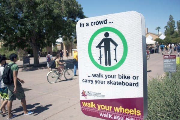 WALK IT OUT: ASU posted 30 signs on the Tempe campus last week encouraging students to get off their wheels in a crowded area. Undergraduate Student Government’s Walk Your Wheels campaign officially kicks off on Sept. 28. (Photo by Shawn Raymundo)