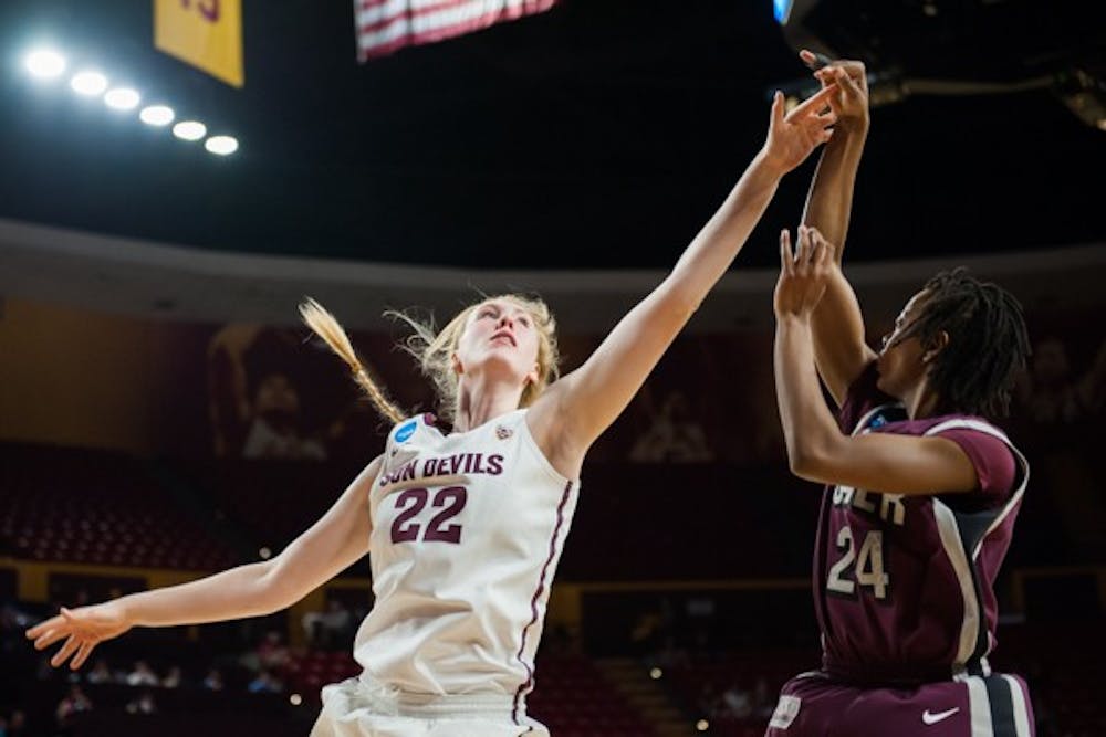 Sophomore center Quinn Dornstauder attempts to block UALR senior guard Taylor Gault's shot in the first half of the second round of the women's NCAA Tournament on Monday, March 23, 2015, at Wells Fargo Arena in Tempe. The Sun Devils came from behind to defeat the Trojans 57-54 and advance to the Sweet 16. (Ben Moffat/The State Press)