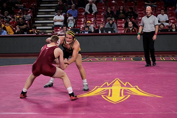 Redshirt sophomore Blake Stauffer grapples with Stanford reshirt freshman Zach Nevills. Stauffer won on a 9-2 decision at a home meet on Feb. 3. (Photo by Benjamin Margiott)