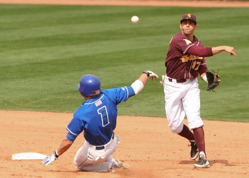 Beat the Runner: ASU sophomore infielder Deven Marrero attempts to throw a runner out at first base during the Sun Devils’ victory over Delaware on Saturday. After losing the series opener on Friday, ASU won three straight games over the Blue Hens. (Photo by Lisa Bartoli)