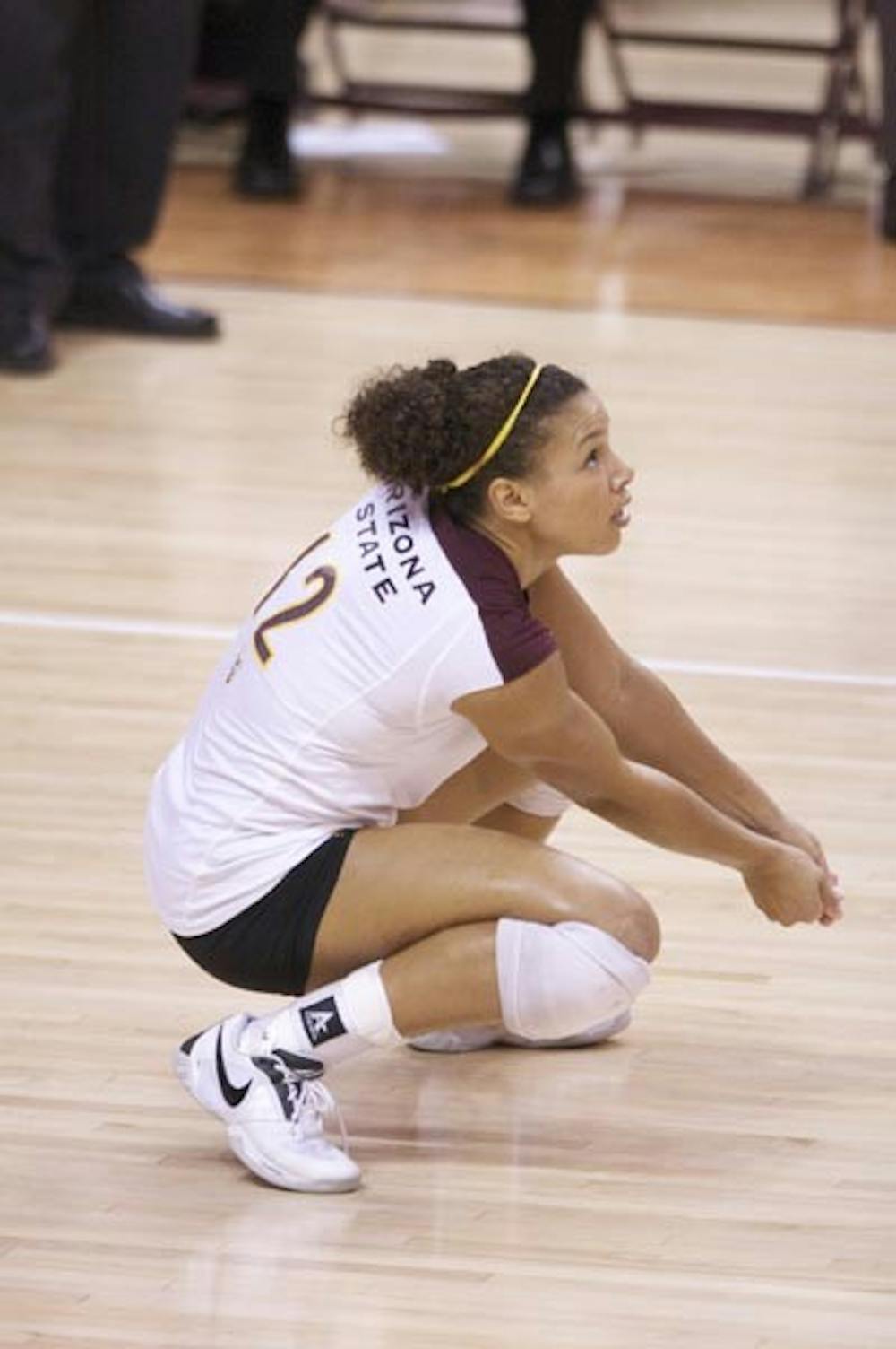 STILL CLIMBING: Senior outside hitter Sarah Reaves crouches low for a bump during a match earlier this season. Over the weekend, Reaves moved into third place on the ASU career kills list, surpassing former volleyball standout Amanda Burbridge. (Photo by Scott Stuk)