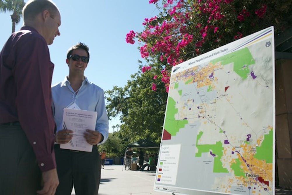 RAIL TALK: Transportation Planner for the Arizona Department of Transportation Intercity Rail Study Ryan Cook discusses the potential development of a rail system between Phoenix and Tucson with Greg Haggerty. (Photo by Shawn Raymundo)