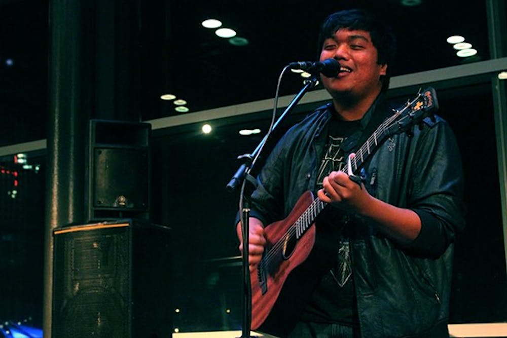 ASU Sociology junior Archie Carreon starts off his set with a song he wrote three days before the open mic night at the Tempe Center for the Arts. Carreon said he found about the TCA open mic from a Facebook page called AZ Open Mic. (Photo by Edmund Hubbard)