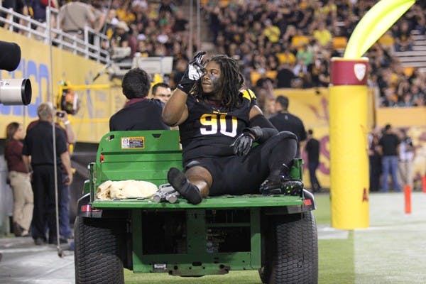 Junior defensive tackle Will Sutton waves to fans as he leaves Thursday’s game against Oregon with an apparent right knee injury. (Photo by Kyle Newman)