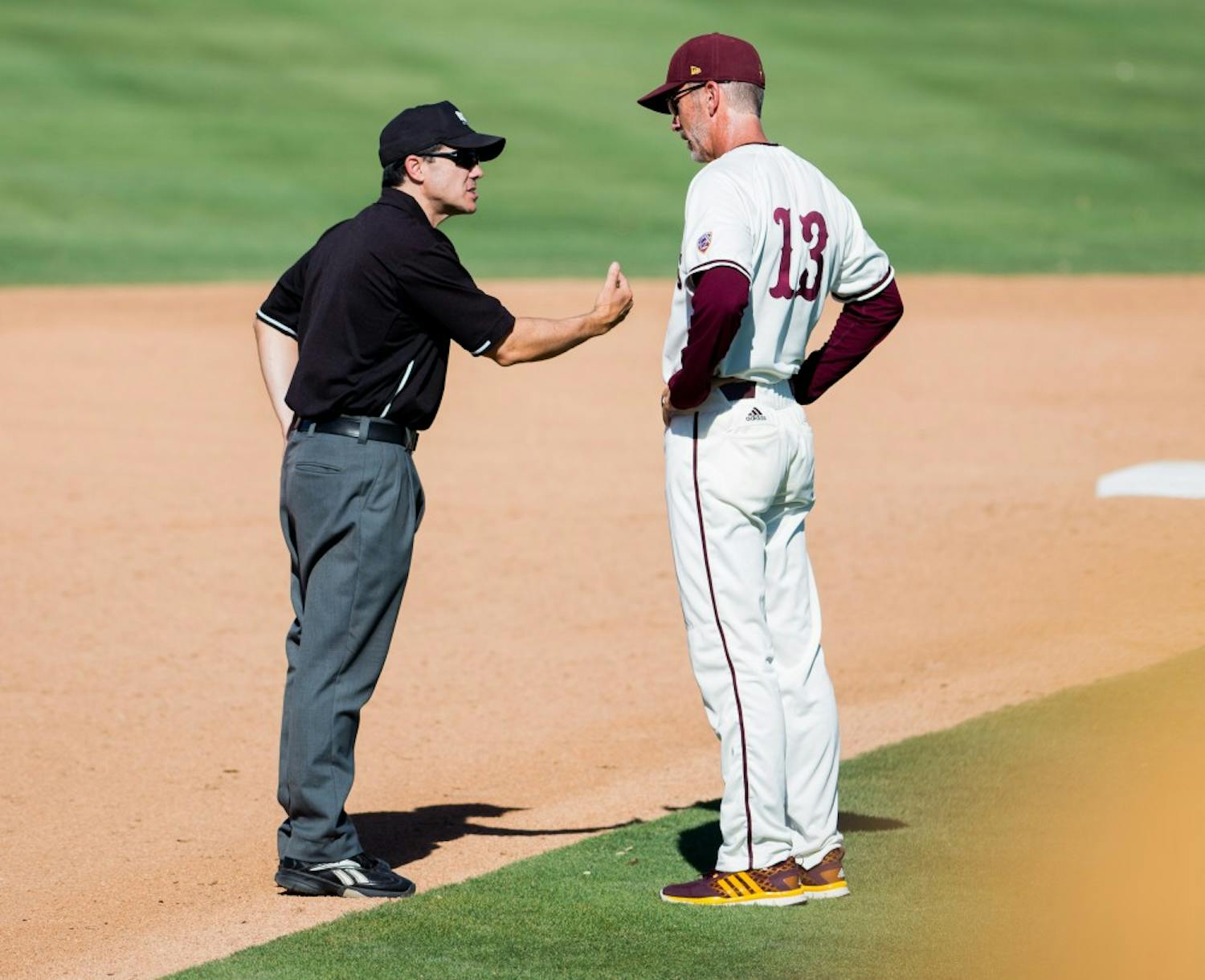 Head coach Tracy Smith argues a call with an umpire during a game against USC on Sunday, May 29, 2016, at Phoenix Municipal Stadium in Phoenix. The Trojans defeated the Sun Devils 31-9.