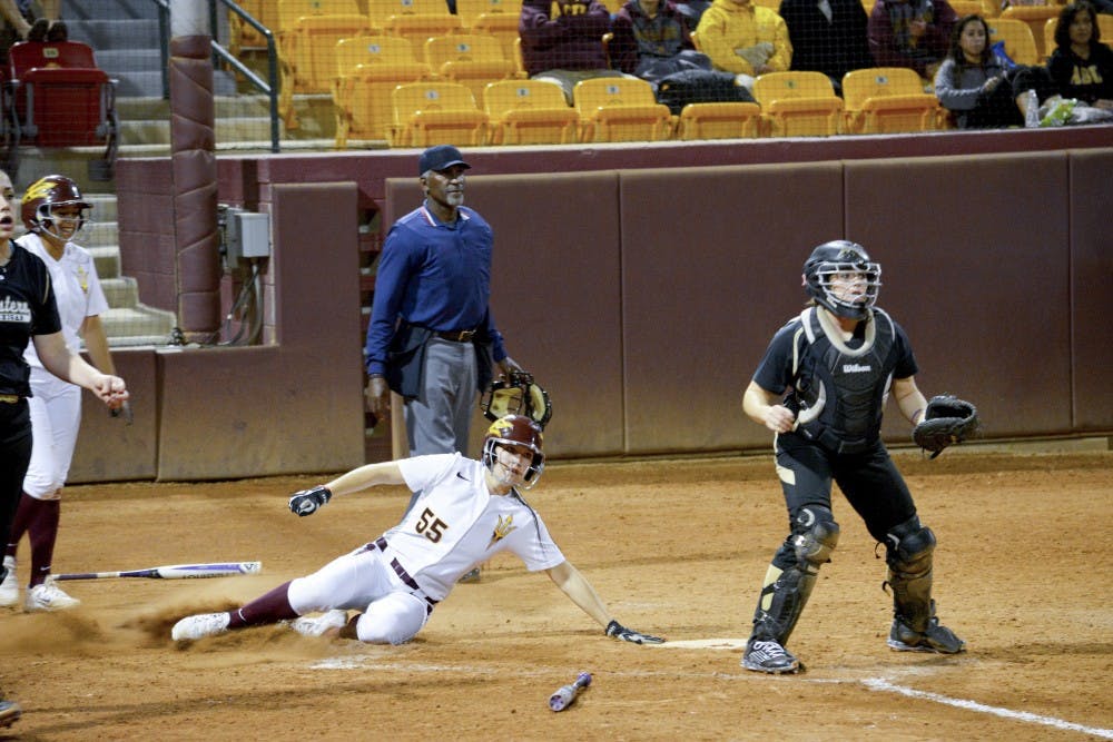 ASU senior Elizabeth Caporuscio slides into home, scoring against Western Michigan, Thursday Feb. 5, 2015 at Farrington Stadium in Tempe. The Sun Devils defeated the Broncos 6-0. (Krista Tillman/ The State Press)