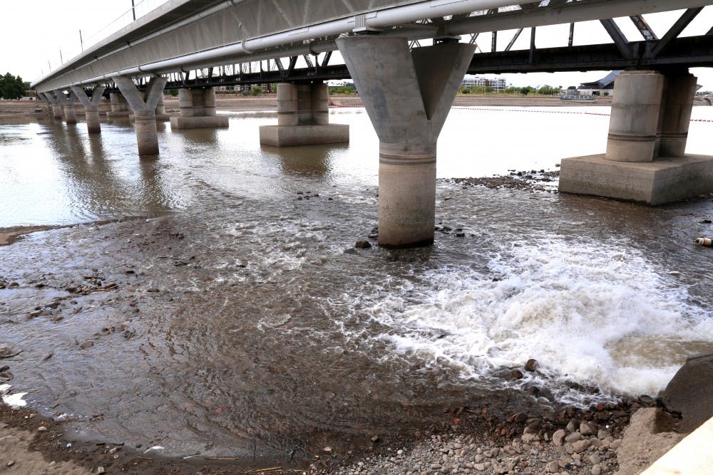 Water rushes from a storm drain to begin the process of refilling Tempe Town Lake on Tuesday, April 12, 2016. Officals say it will take roughly two weeks to refill the lake with 900-million gallons of water. 
