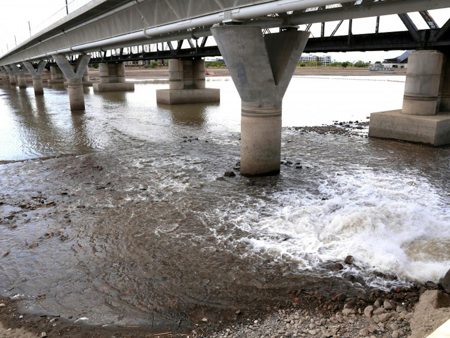 Water rushes from a storm drain to begin the process of refilling Tempe Town Lake on Tuesday, April 12, 2016. Officals say it will take roughly two weeks to refill the lake with 900-million gallons of water. 