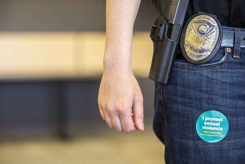 Jennifer Bryner, a sexual assault detective with the ASU police department, shows off a sticker from "Denim Day" on April 12, 2016.
