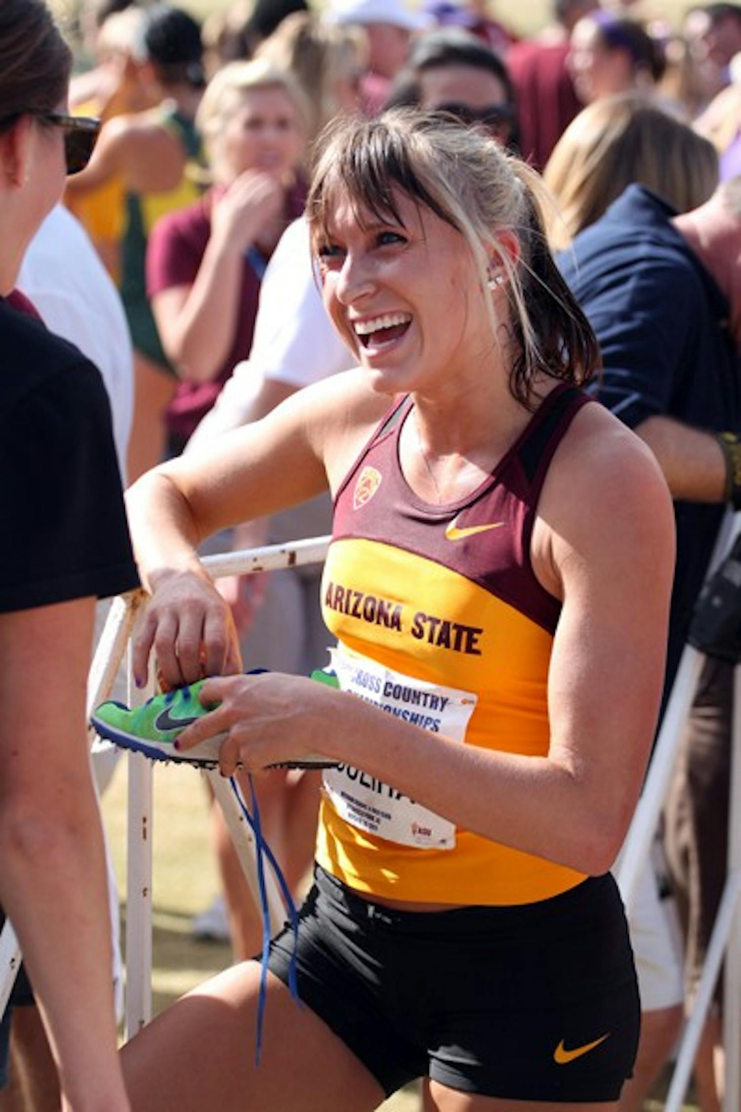 TICKET PUNCHED: ASU freshman Shelby Houlihan takes off her running spikes after the Pac-12 Championships in October. Houlihan’s performance at the NCAA West Regionals on Saturday helped the Sun Devil women make Nationals. (Photo by Elijah Grasser)