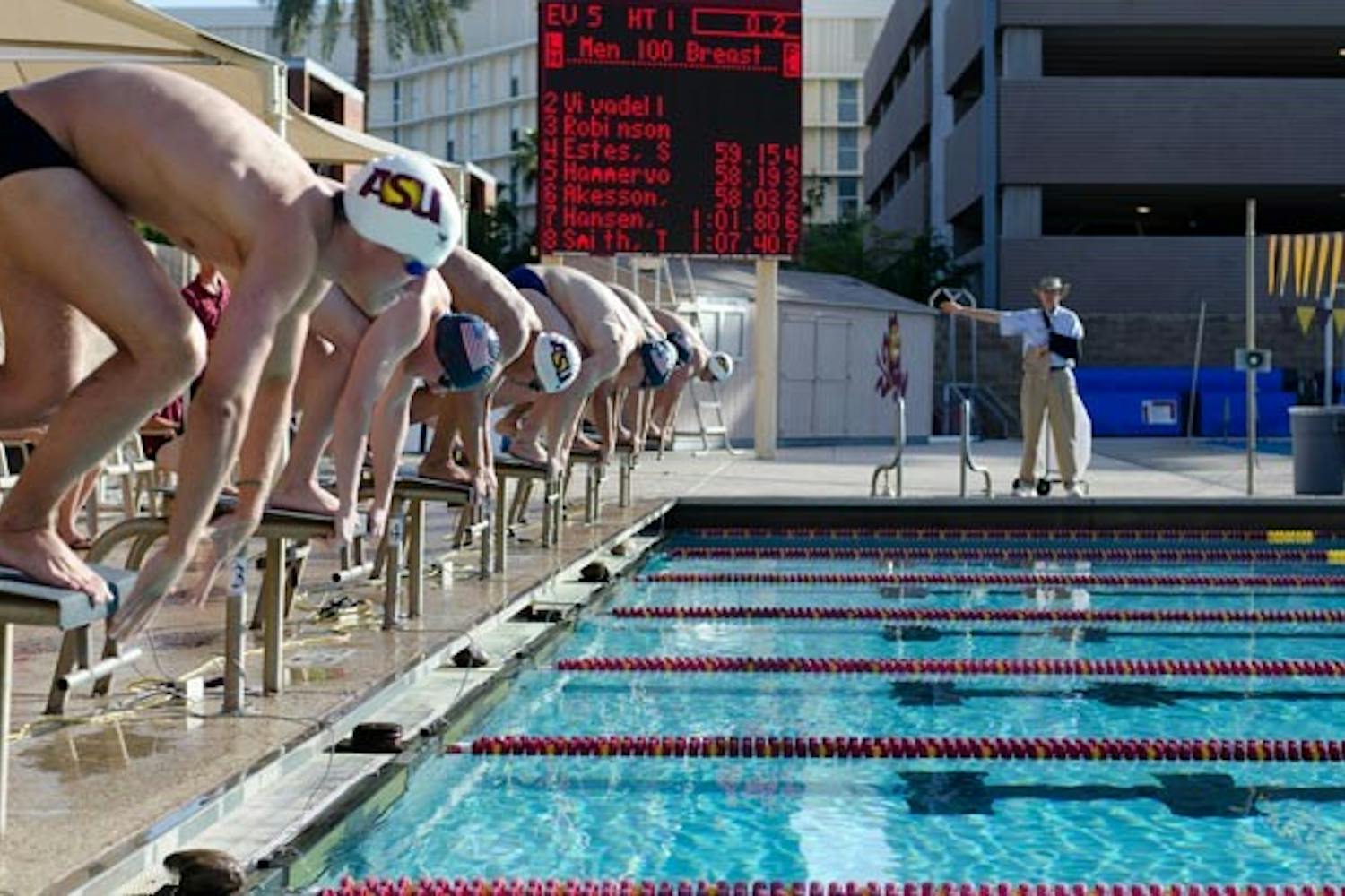 TAKE YOUR MARK: Air Force and ASU men's swimmers line up on the starting blocks during Friday's meet at Mona Plummer Aquatic Center. Air Force dominated the meet, taking 13 of 14 events from the young Sun Devils team. (Photo by Aaron Lavinsky)