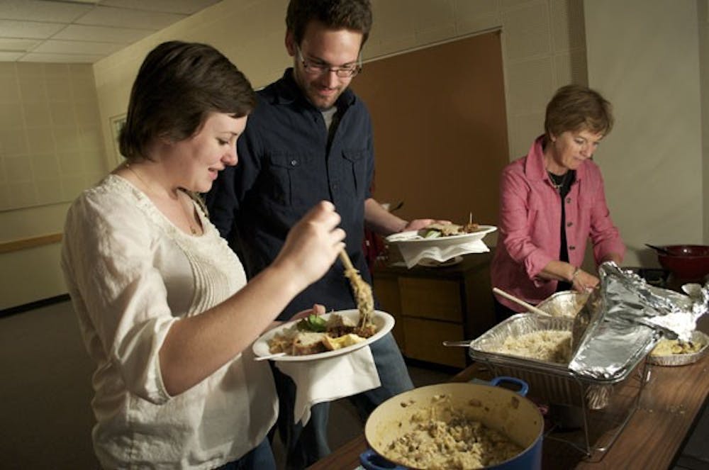 DINING MEDIEVAL STYLE: Allison Walsh, a sophomore special education and spanish major, and Jeff Wheatley, a junior english and history major, fill their plates at the second annual Medieval Feast to honor the poet Geoffrey Chaucer, put on by the ASU English departments and the Arizona Center for Medieval and Renaissance Studies. (Photo by Molly Smith)