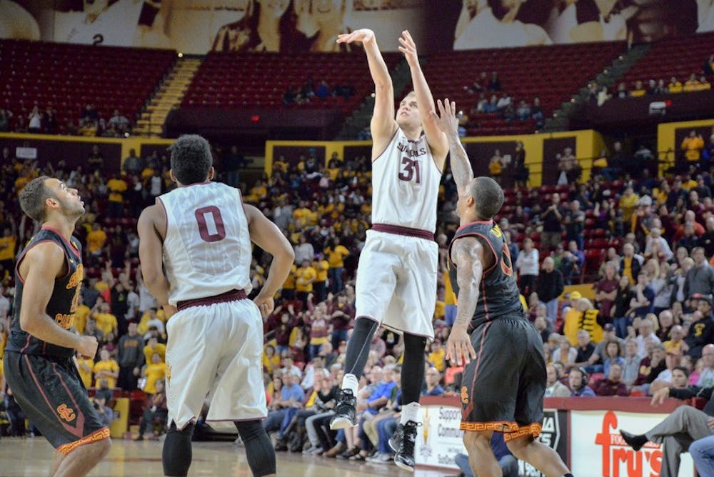 Senior Jonathan Gilling scores a Sun Devil 3-pointer to retake the lead with 42 seconds left on the clock on Feb. 22, 2015, at the Wells Fargo Arena. The Sun Devils would win the game 64-59 over the USC Trojans. (J. Bauer-Leffler/The State Press)