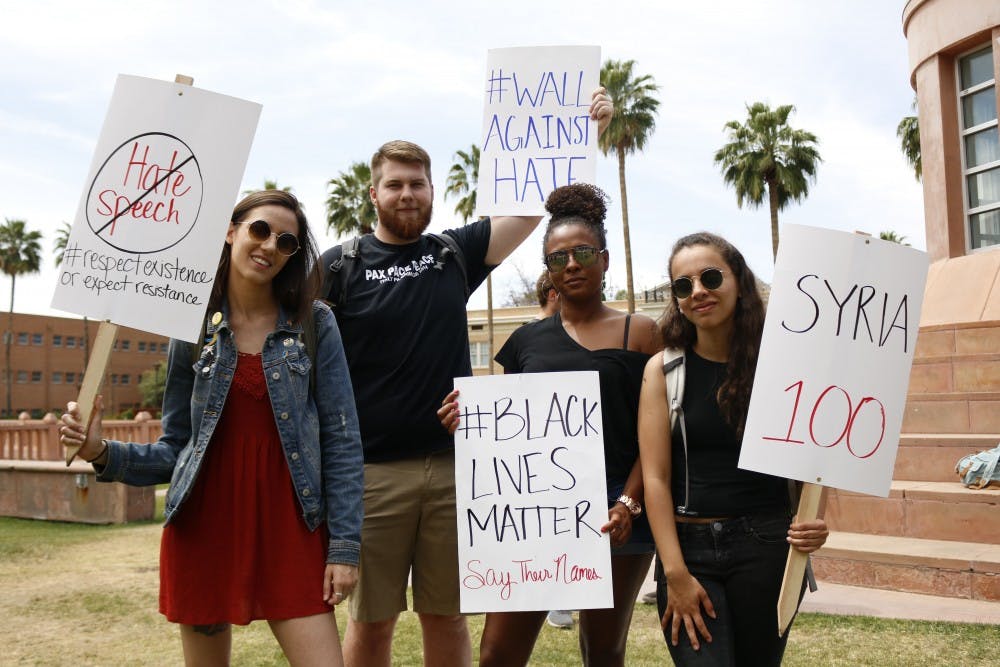 ASU students participating in the Walk Out Against Hate protest pose for a photo on Hayden Lawn in Tempe, Arizona on Thursday, April 13, 2017. 