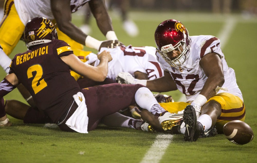 Redshirt senior quarter back Mike Bercovici (2) loses control of the ball during the first half of a game against USC on Saturday, Sept. 26, 2015, at Sun Devil Stadium in Tempe. The USC Trojans led the ASU Sun Devils 35-0 halfway through their first face-off of the year. 