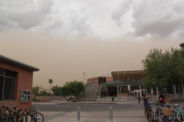THE EXTREMES: ASU students experience two Arizona weather extremes the first day back to school. During the hottest part of the day, temperatures reached 112 degrees. Later the Tempe campus was hit by a dust storm.  (Photo by Beth Easterbrook)