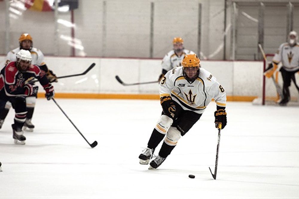Forward Eric Rivard makes a break down the ice at a home game against UA on Saturday, Oct. 11, 2014. ASU beat UA 3-0. (Photo by Mario Mendez)