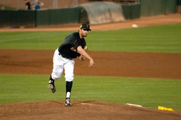 Freshman pitcher Seth Martinez sends the ball to first base to prevent a steal. ASU defeated Wichita State 9-4 on March 18, 2014. (Photo by Mario Mendez)