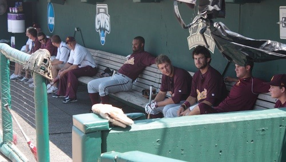 Members of the ASU baseball team wait in the dugout before their game against South Carolina at the College World Series. ASU was eliminated with an 11-4 loss. (Photo by Nick Kosmider)