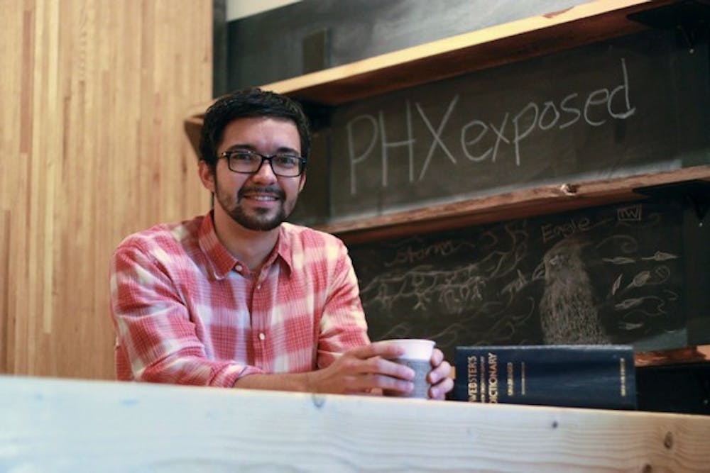 NEW EXPERIENCES: Creator of PHXexposed Kevin Mulvin poses at Royal Coffee Bar in the Phoenix Public Market on Thursday morning.  PHXexposed links the community with local businesses through drawings that give the winner a chance to try new places. (Photo by Lillian Reid)