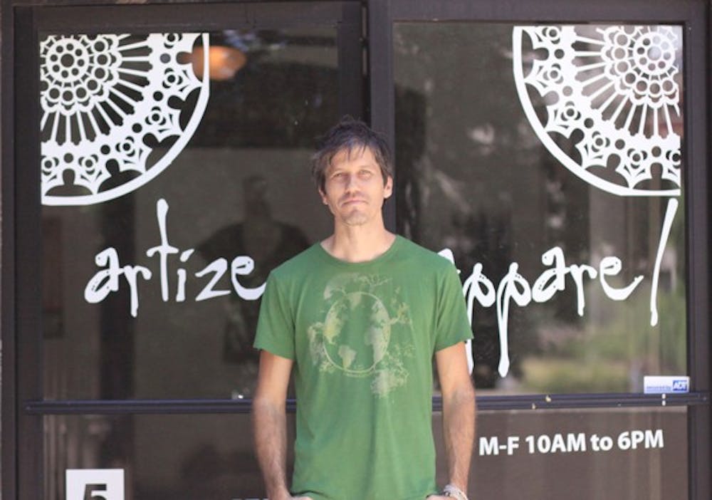 GOING GREEN: Scott Allison stands in front of his newly opened eco-friendly t-shirt shop. Artizen Apparel opened in July and Aliison says the shop offers "planet-friendly fashion". (Photo by Lillian Reid)