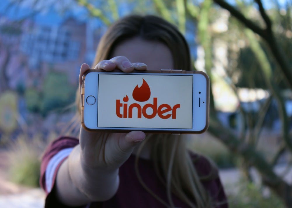 ASU student flashes her iPhone screen showing her tinder app ouside of Taylor Place Friday, Jan. 27.