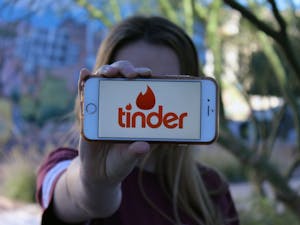ASU student flashes her iPhone screen showing her tinder app ouside of Taylor Place Friday, Jan. 27.