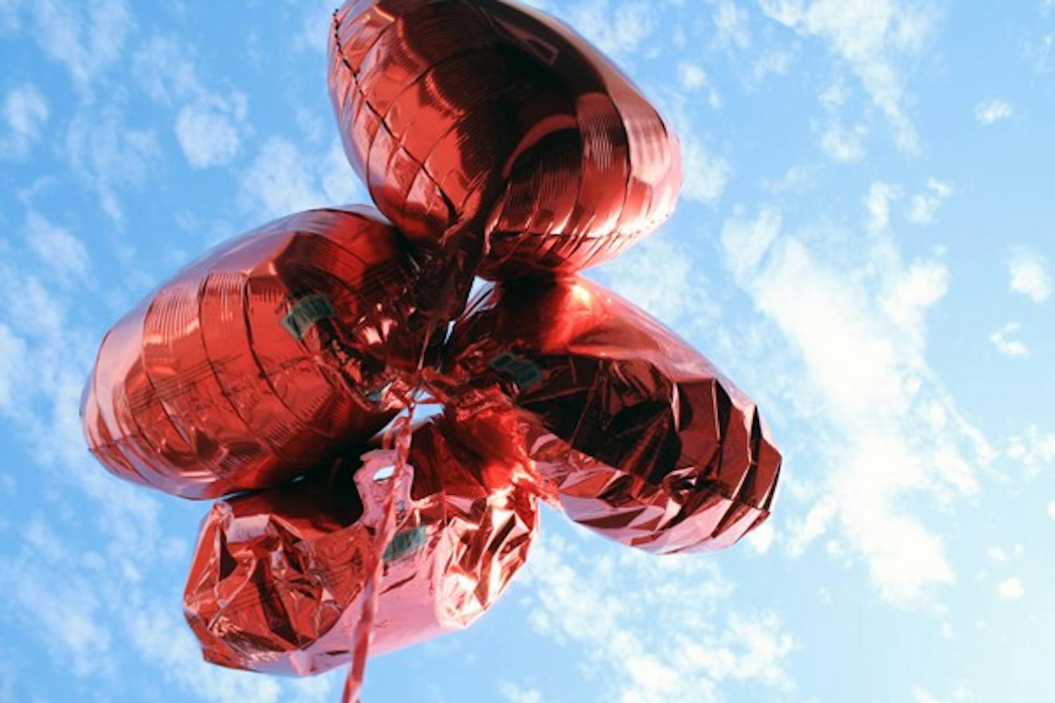 A bouquet of red heart balloons float under the sky near Sparky's Old Town Creamery on Mill Avenue Monday afternoon. (Photo by Jessie Wardarski)