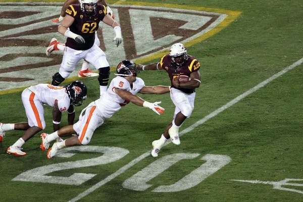 HIGHLIGHT-REEL RUN: ASU junior running back Cameron Marshall stiff-arms an opponent during his 37-yard touchdown run in the third quarter of the Sun Devils' 35-20 victory over Oregon State. Marshall finished the game with 80 yards and two touchdowns on 14 carries. (Photo by Beth Easterbrook)