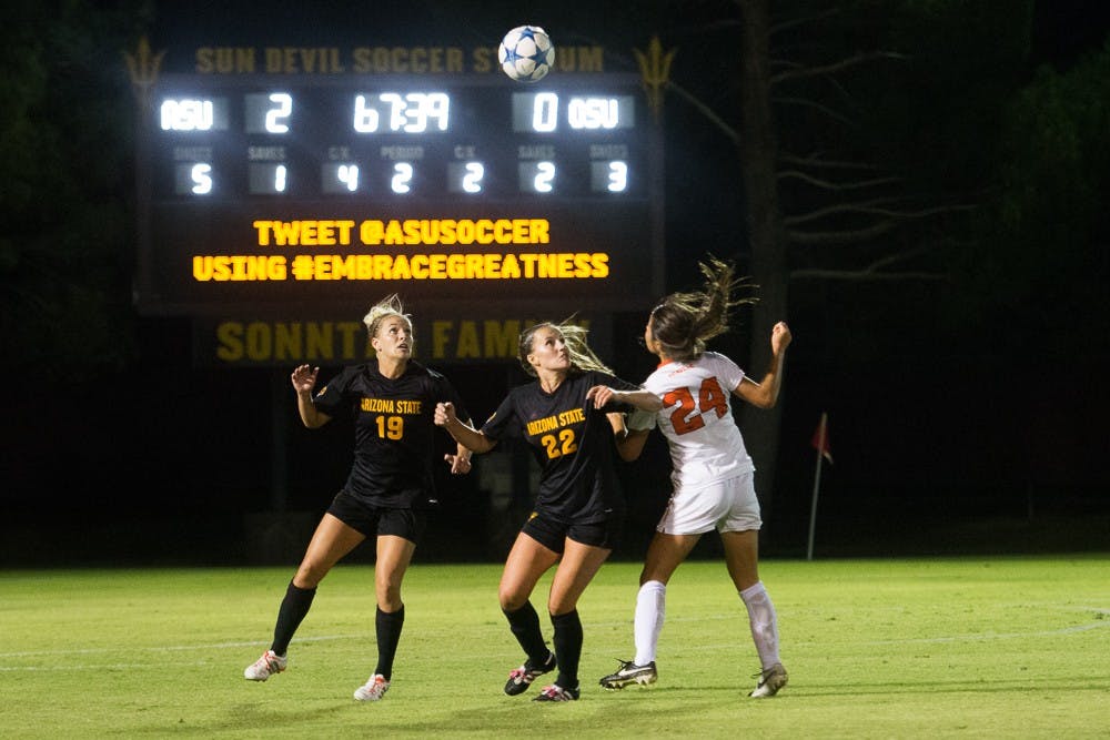 Junior defender McKenzie Grossman and sophomore defender Madison Stark prepare to head the ball on Friday, Oct. 23, 2015, at Sun Devil Soccer Stadium in Tempe.