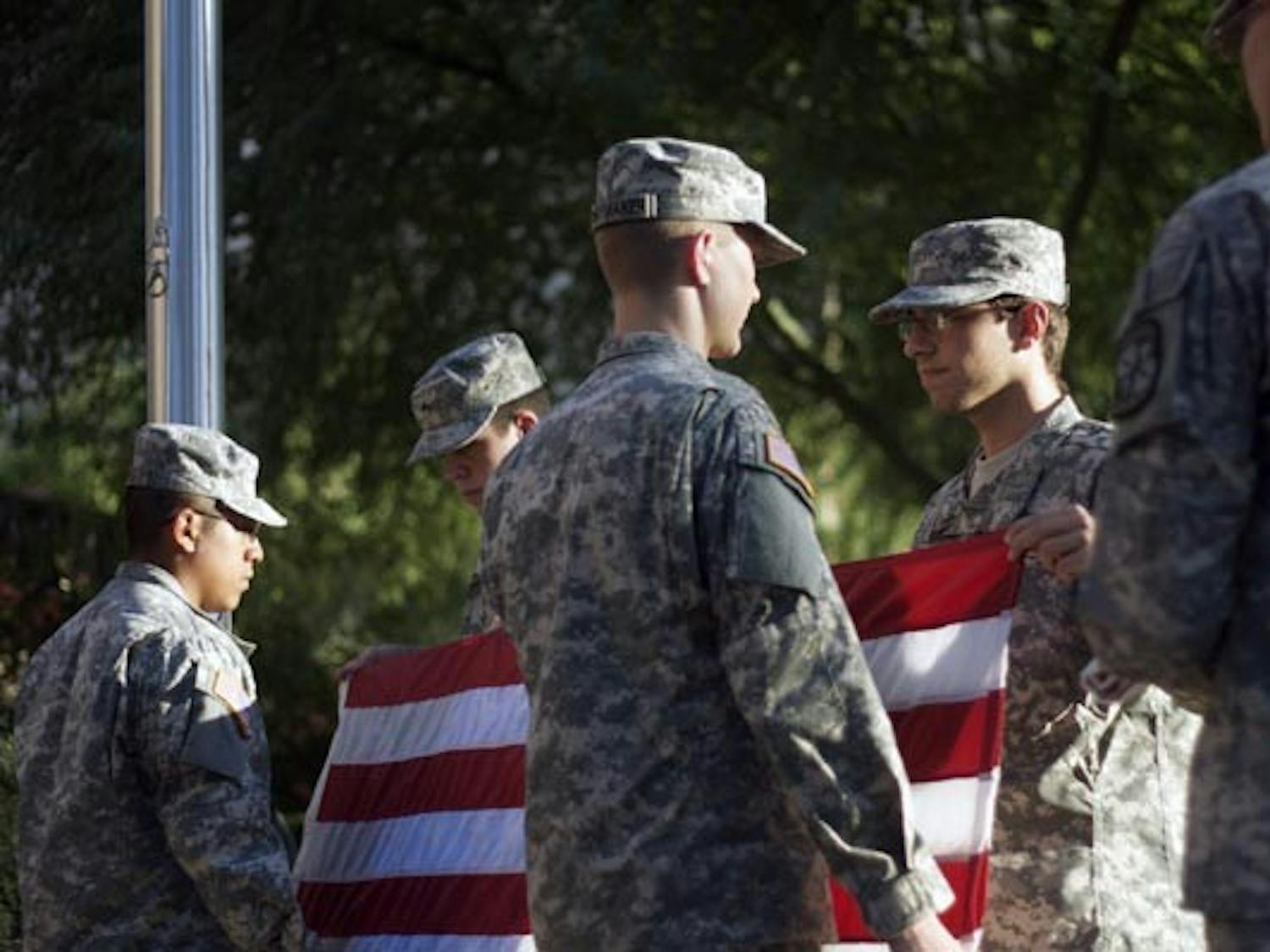 Members of the ROTC color guard take down the American flag in front of the Social Sciences building in Tempe, Arizona on Thursday, Oct. 14, 2010.