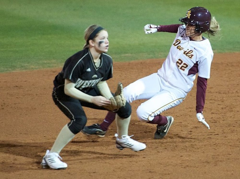 New Impact: ASU junior Taylor Haro slides behind a Western Michigan defender during the Sun Devils’ 17-0 victory on Feb. 10. Haro has solidified her position in left field, hitting .481 in a 12-game hitting streak. (Photo by Michael Arellano)