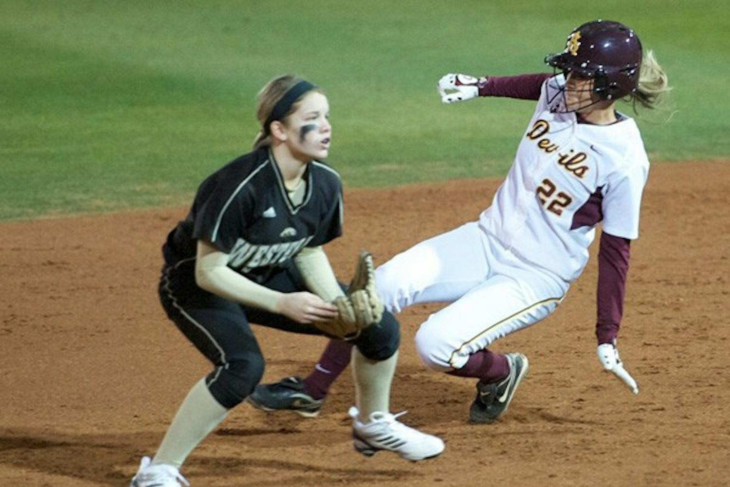 New Impact: ASU junior Taylor Haro slides behind a Western Michigan defender during the Sun Devils’ 17-0 victory on Feb. 10. Haro has solidified her position in left field, hitting .481 in a 12-game hitting streak. (Photo by Michael Arellano)