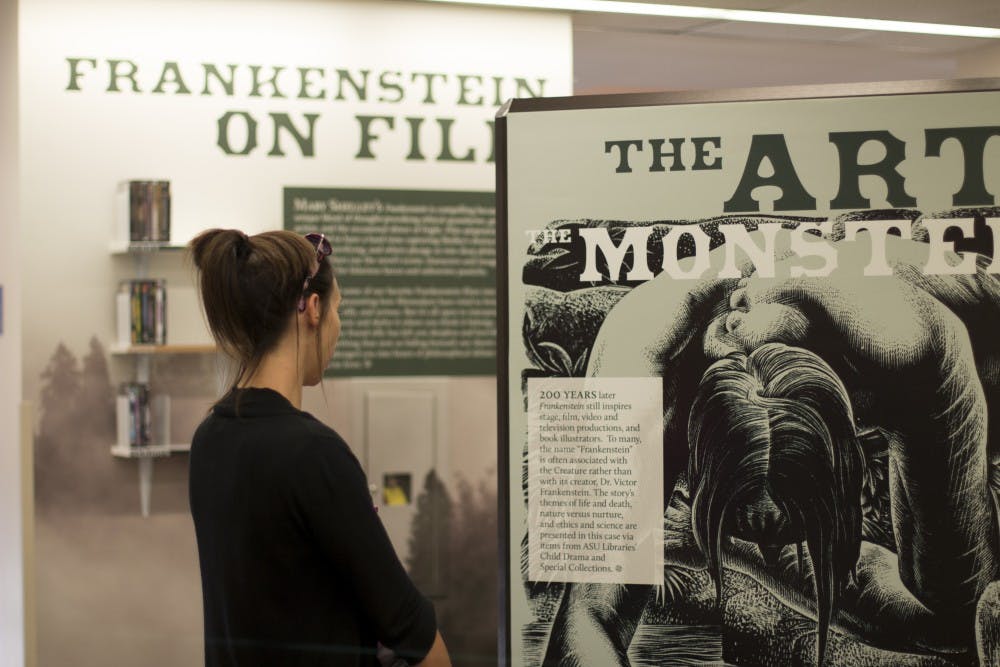ASU public service major&nbsp;Jordyn Kush reads a brief&nbsp;history of "Frankenstein" in the exhibit at Hayden Library on Sept. 14. The exhibit runs through December 2016.