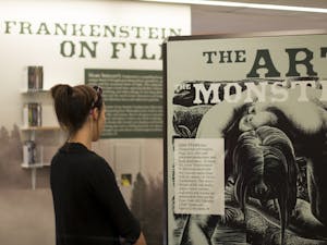 ASU public service major&nbsp;Jordyn Kush reads a brief&nbsp;history of "Frankenstein" in the exhibit at Hayden Library on Sept. 14. The exhibit runs through December 2016.