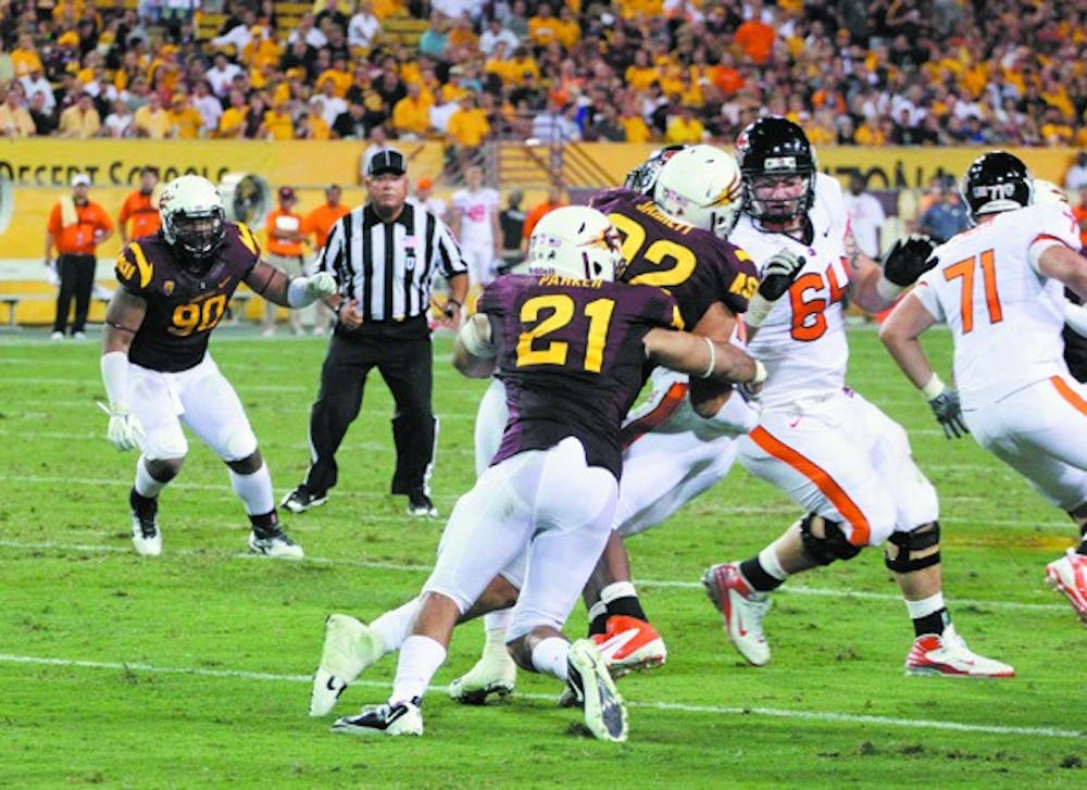 BEEN THERE: ASU redshirt senior linebacker Colin Parker helps out on a tackle during the Sun Devils’ win over Oregon State. Parker tore his ACL in high school and knows what Omar Bolden, who has the same injury, is going through.  (10.27) FBnote