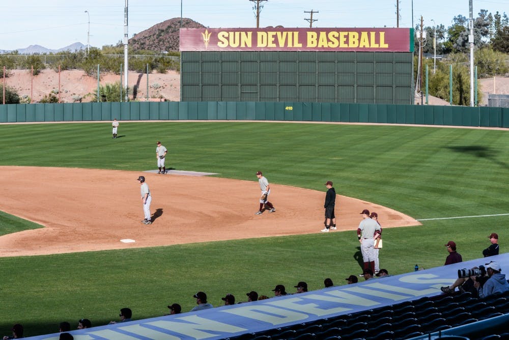 With the new “Sun Devil Baseball" sign behind them in center field, the 2015 ASU baseball team practices for the first time of the season on Jan. 23, 2015, at Phoenix Municipal Stadium in Phoenix. (J.Bauer-Leffler/The State Press)