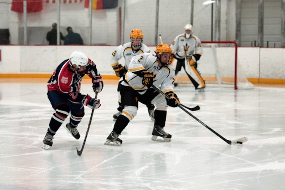 ASU defenseman Drew Newmeyer looks for an open teammate during the game against UA on Oct. 11. ASU closed out UA 3-0 on Oct 11.