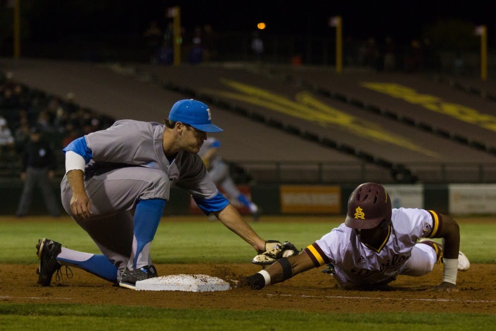 ASU sophomore outfielder Tyler Williams (25) dives back to first base after an attempted pick-off attempt during game one of a three game baseball series versus the UCLA Bruins at Phoenix Municipal Stadium in Phoenix on Friday, March 31, 2017. ASU lost 9-3.