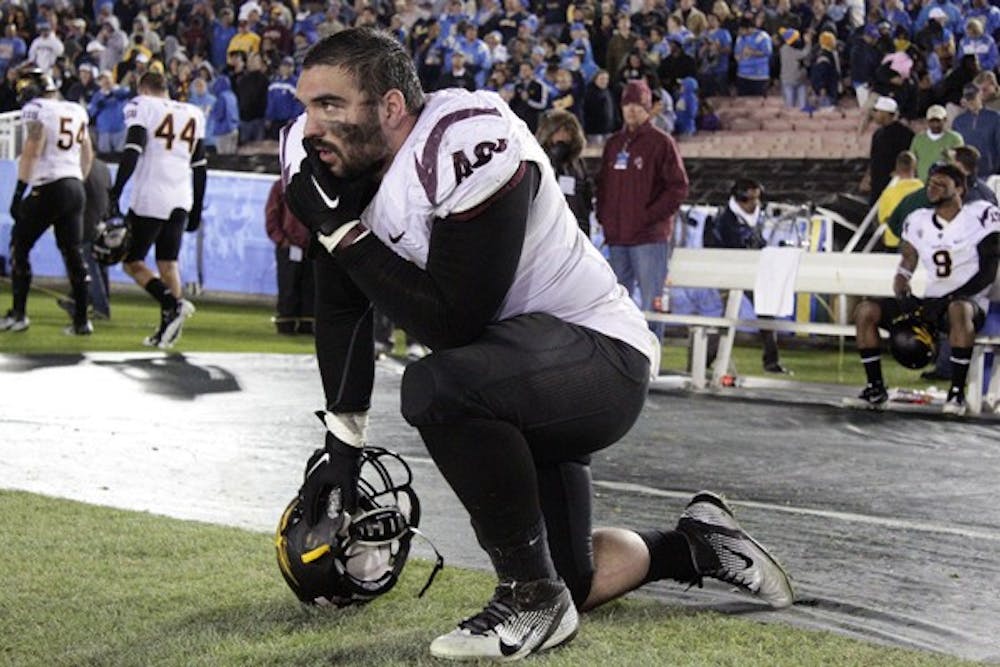 NO ROOM: ASU redshirt senior Bo Moos kneels on the sideline after the Sun Devils’ 29-28 loss to UCLA on Saturday. ASU will likely have to win out in order to reach the Pac-12 title game. (Photo by Beth Easterbrook)