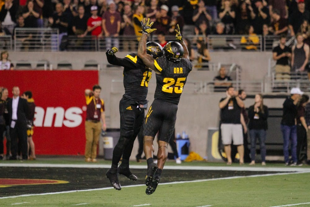 Armand Perry (13) and Kareem Orr (25) celebrate after a Sun Devil touchdown during a football game against Utah in Sun Devil Stadium in Tempe, Arizona, on Thursday, Nov. 10, 2016.