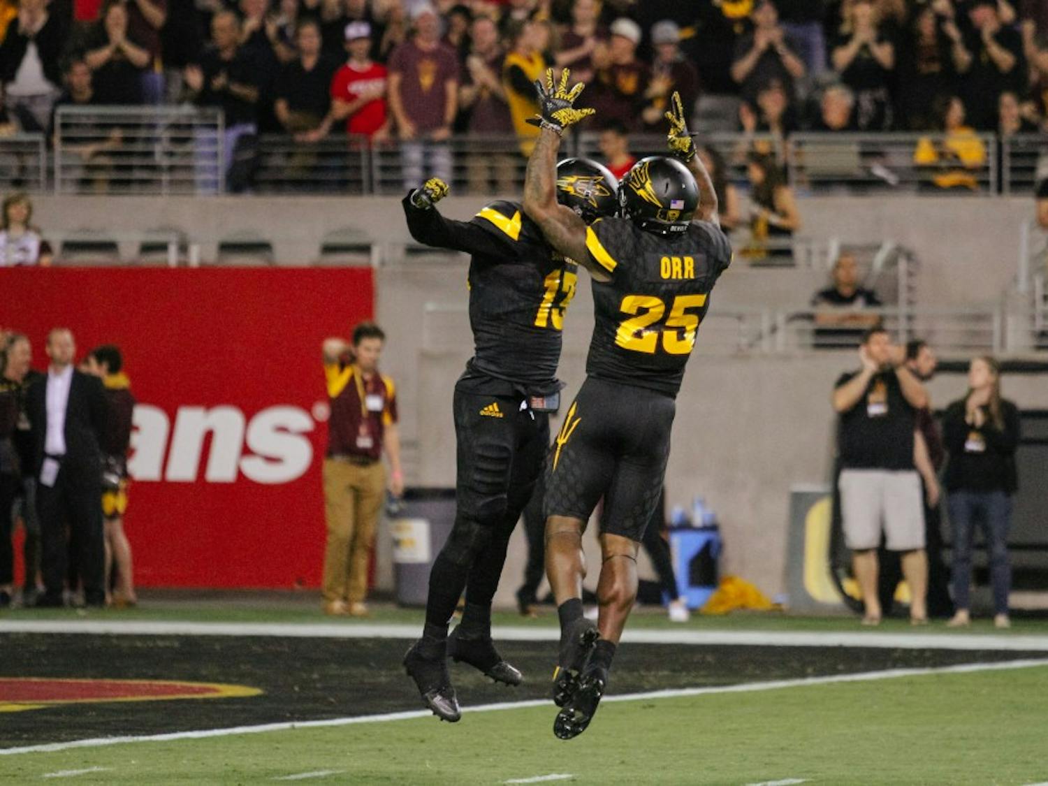 Armand Perry (13) and Kareem Orr (25) celebrate after a Sun Devil touchdown during a football game against Utah in Sun Devil Stadium in Tempe, Arizona, on Thursday, Nov. 10, 2016.