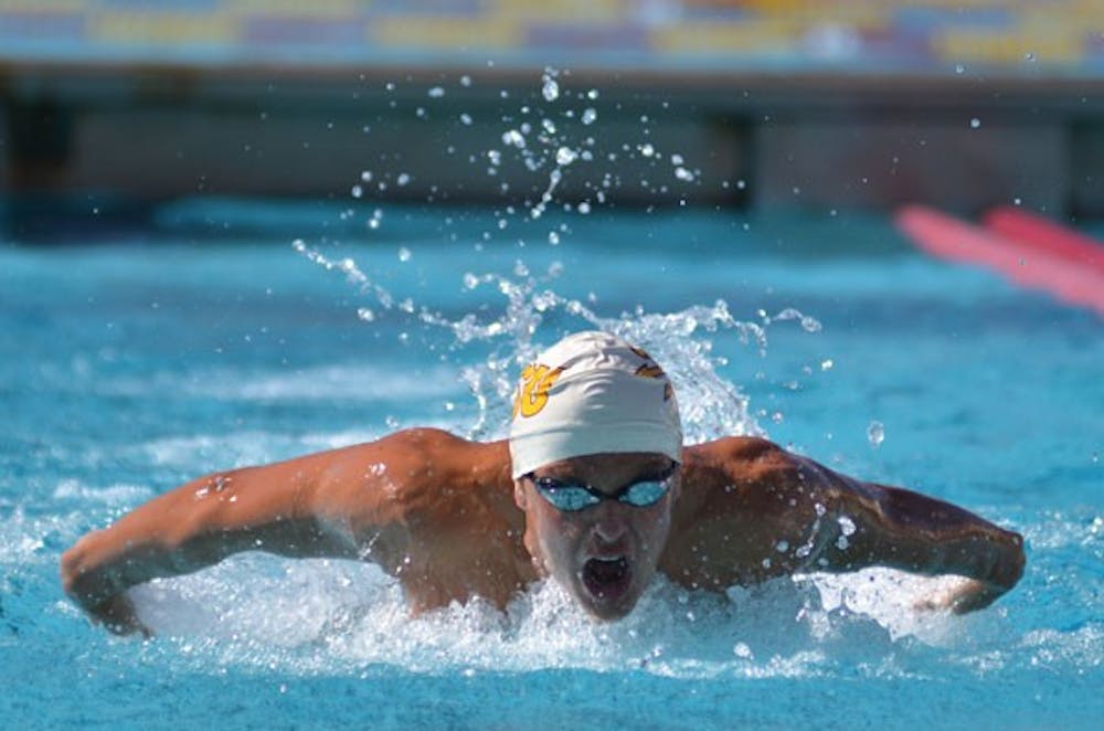 Sophomore Zac Dalby takes a breath in the butterfly during ASU’s meet against UA on Feb. 11. (Photo by Aaron Lavinsky)