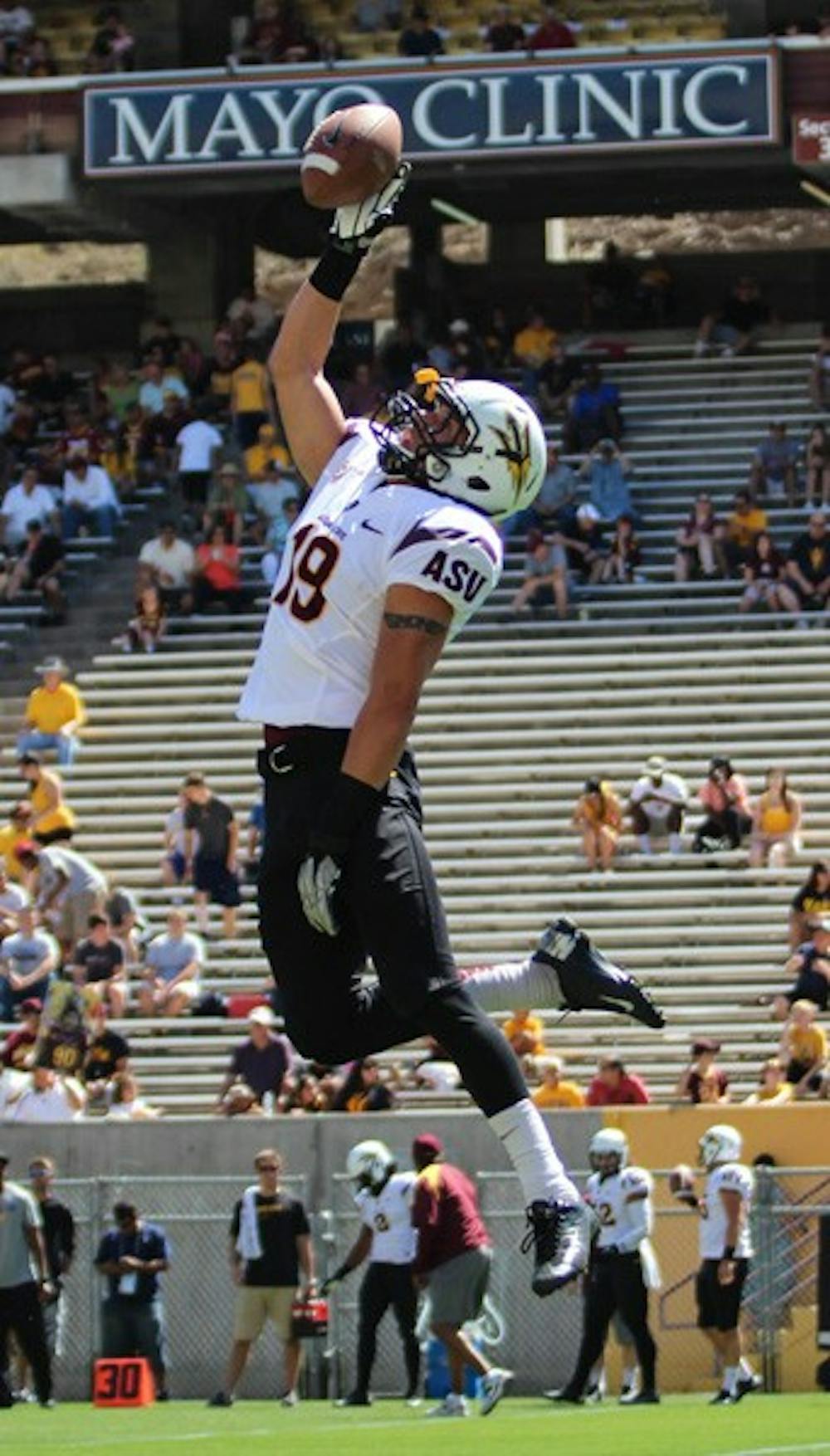 Senior defensive back Jordan Simone leaps for a catch in warmups during the Sun Devils' Fan Fest on April 13. ASU coach Todd Graham was impressed with the defense during the spring game. (Photo by Dominic Valente.)
