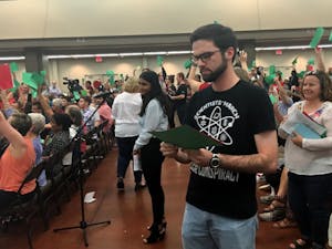 ASU Ph.D student John Christoph reviews his question before speaking at Jeff Flake's town hall meeting in Mesa, Arizona&nbsp;on Thursday, April 13, 2017.